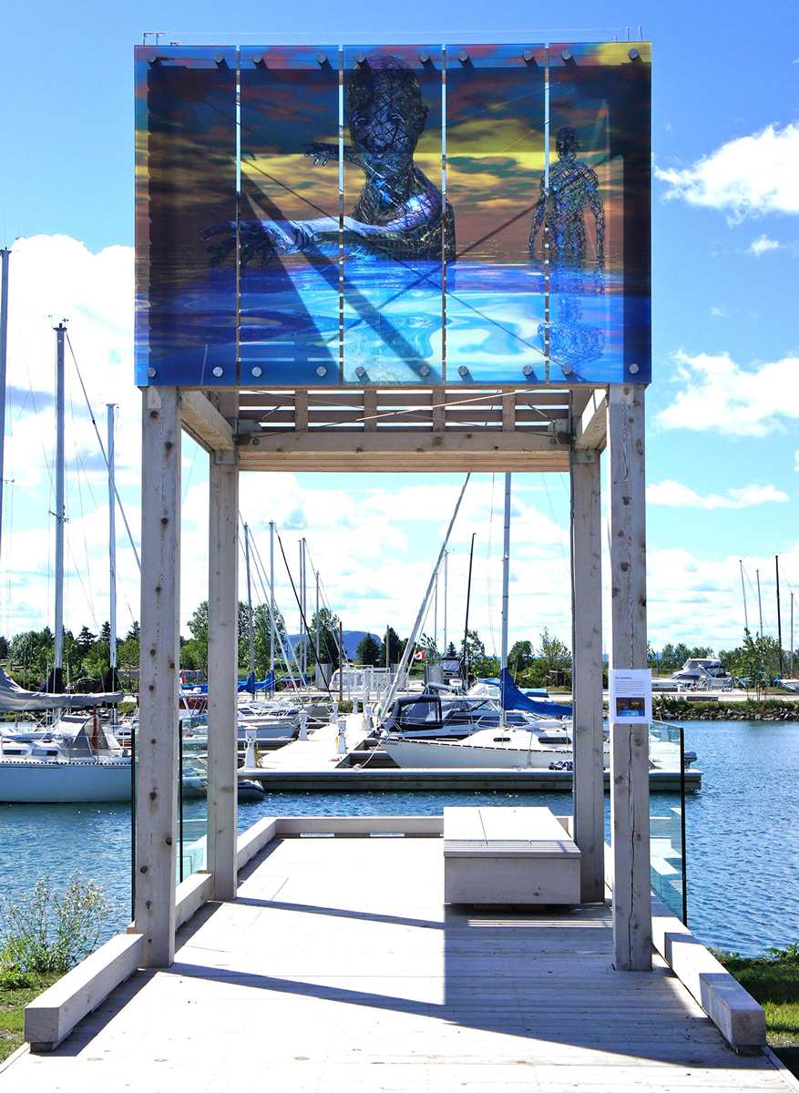 Glass panels painted with abstract figures emerging from the sea, installed above a pier leading to a marina docked with sailboats