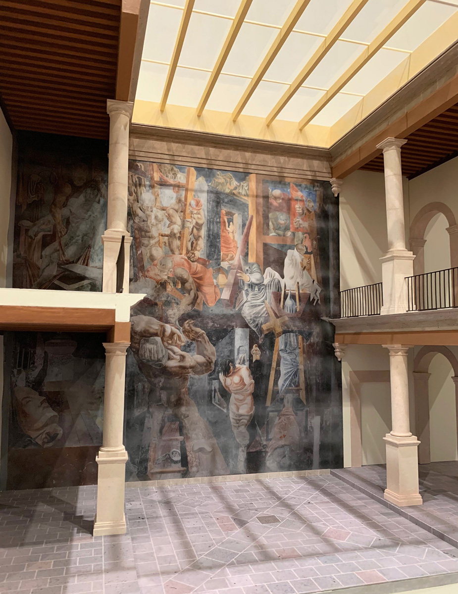 Architectural model of a two-story mural flanked by columns, within a glass-ceiling atrium