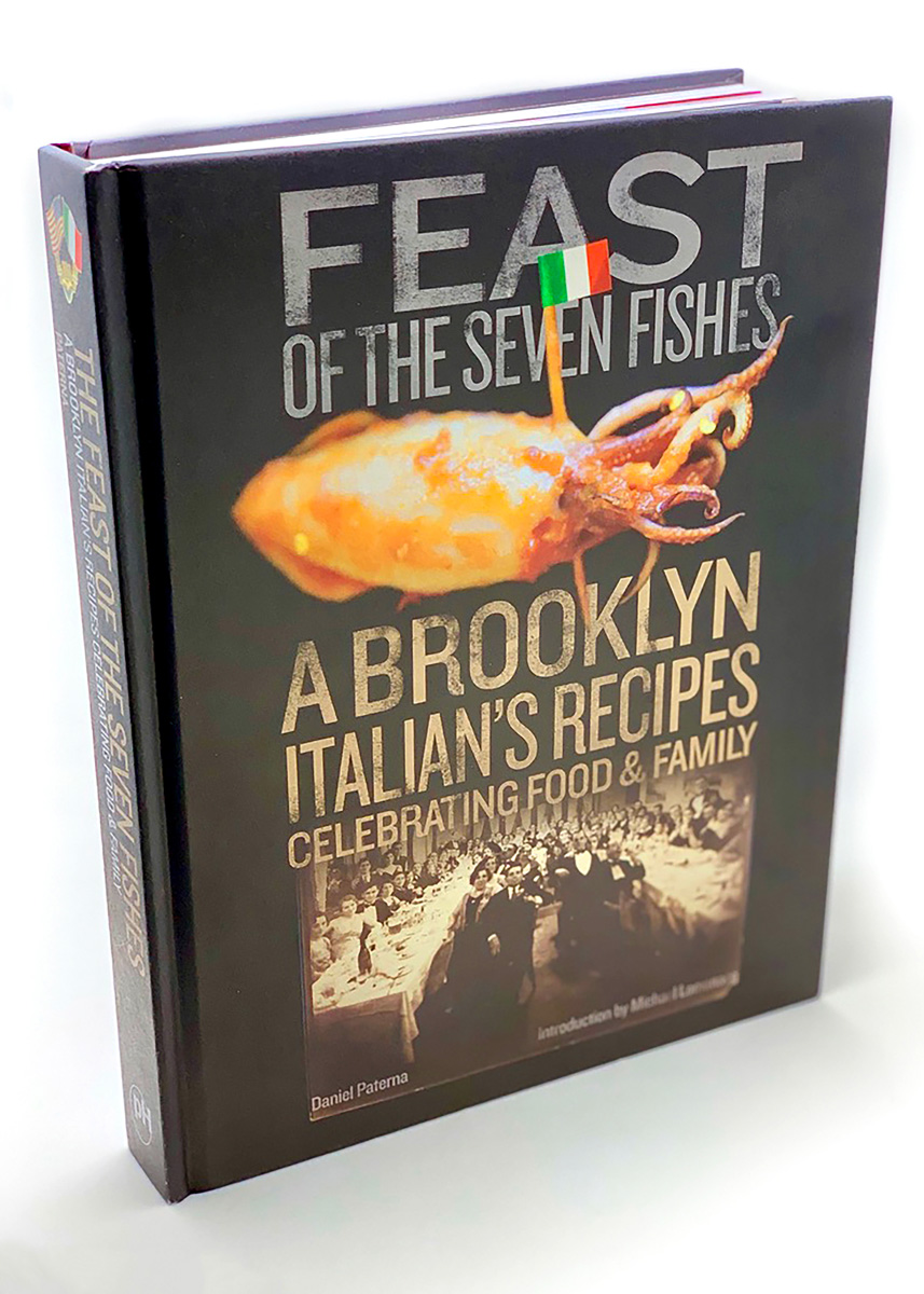 Book cover of Feast of the Seven Fishes depicting cooked squid pierced with Italian-flag-topped toothpick