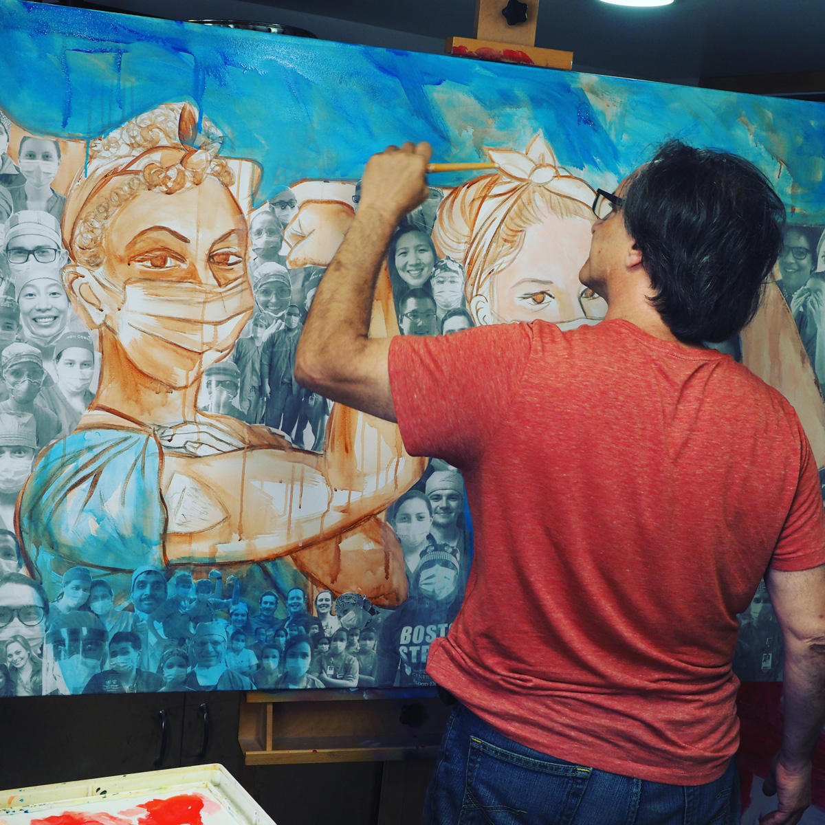 Artist Antonio Reonegro paints a large artwork depicting frontline responders at Mass General Hospital during COVID-19