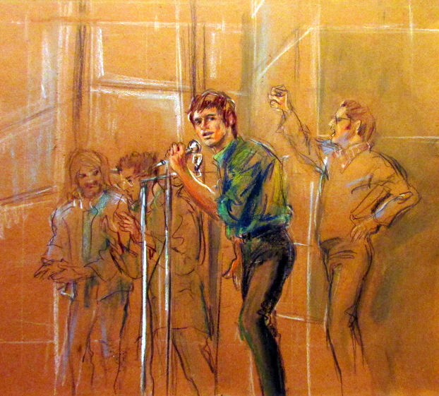 A sketch of a light-skinned man in a blue button-down and black trousers speaking into a microphone in a courtroom