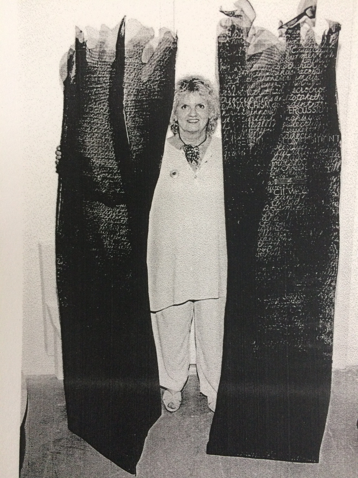 Claire Jeanine Satin stands between two long sculptures