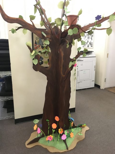a tree, made of paper and fabric, in a room, with copy machine and equipment