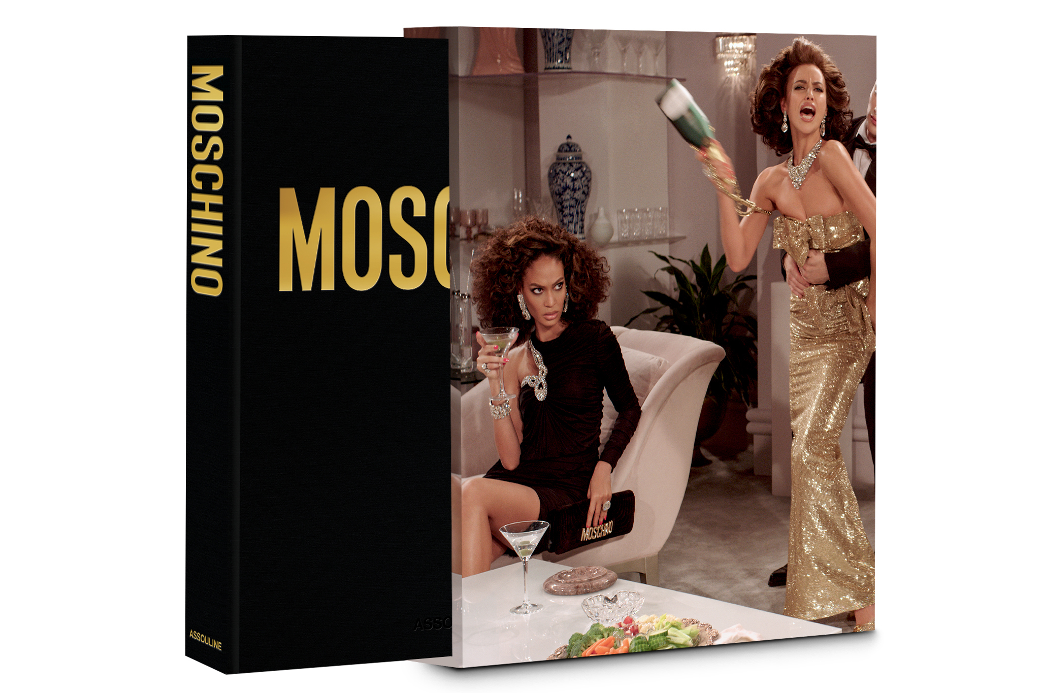 Book pulled slightly from slipcover featuring a photo of fashion models in gowns and a tuxedo staging a fight with a champagne bottle