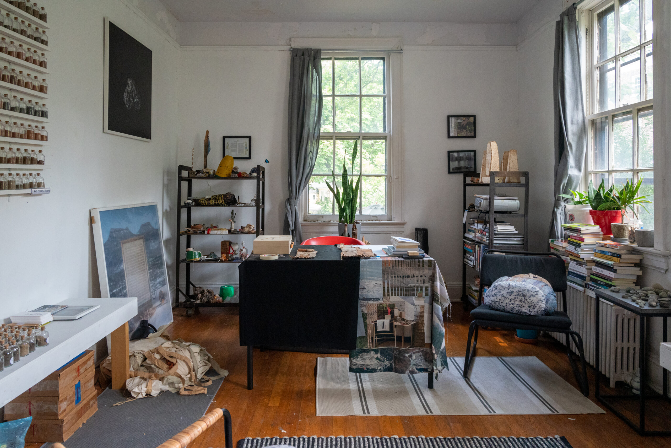 Room with shelves and surfaces covered with jars, sculptures, and other small items