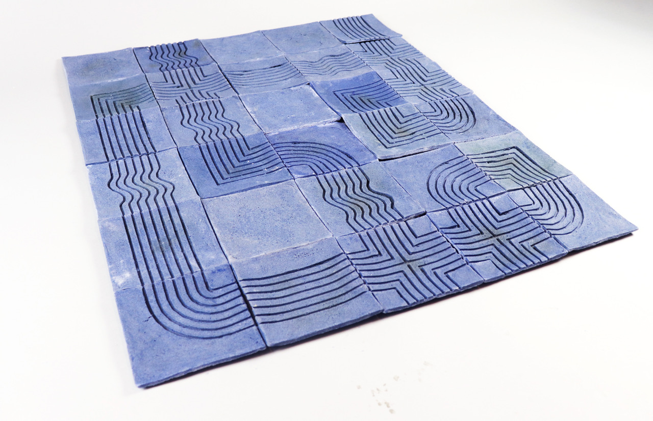 A layout of blue tiles etched with curved and straight line patterns