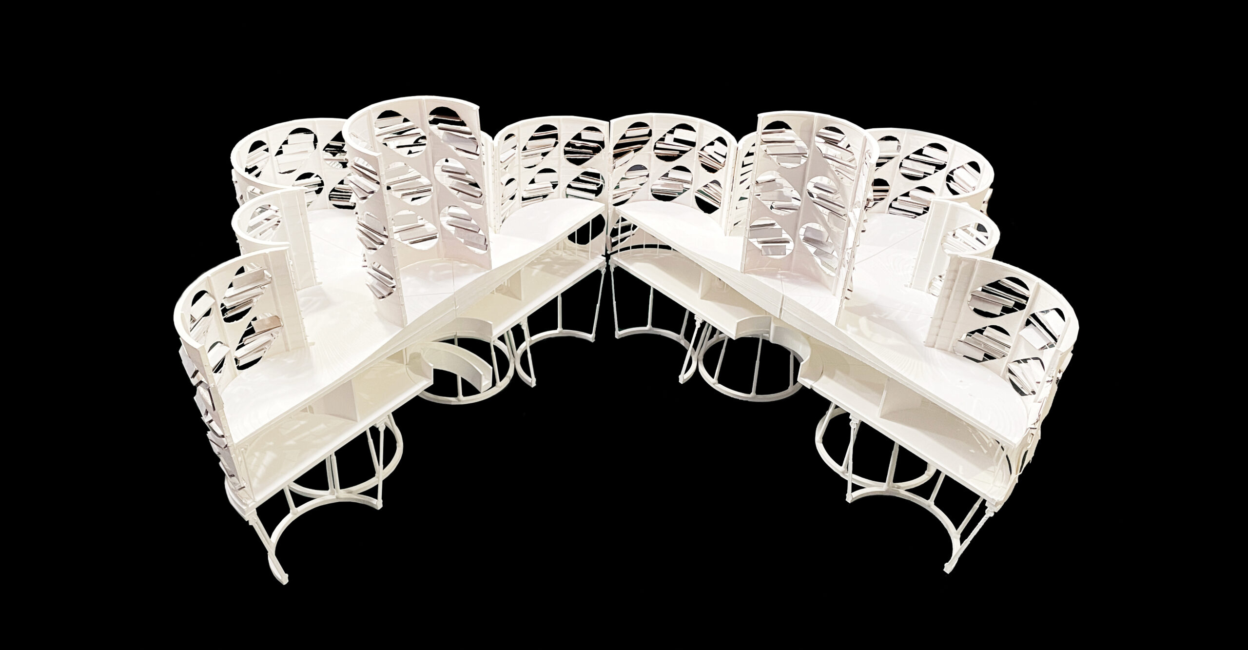 White architectural model with curved walls embedded with wind turbines opened to reveal the interior levels and rooms