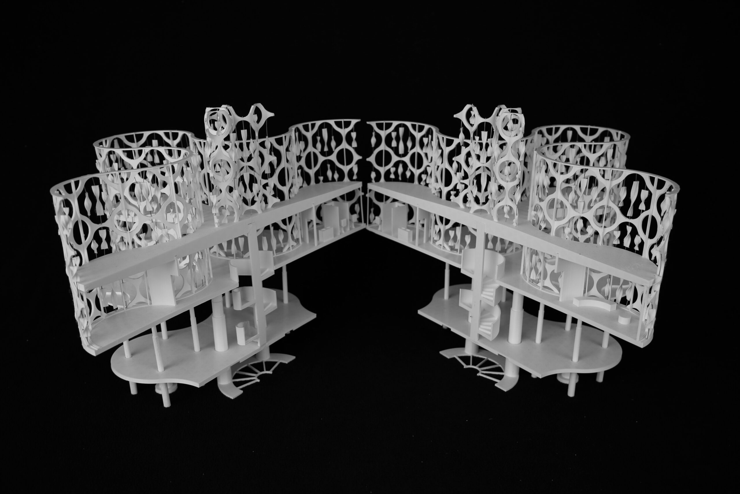 White architectural model open to reveal interior levels, stairs, and seating areas
