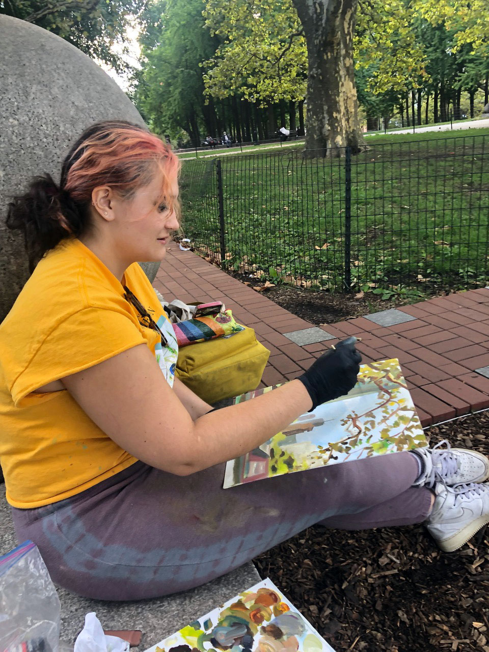 A person sitting in a park and painting