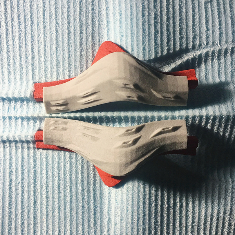 Abstract render of a morphological structure in red, beige and light blue.