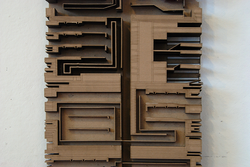 A top-down view of an architectural render in brown. The structure has labyrinthine pathways throughout.