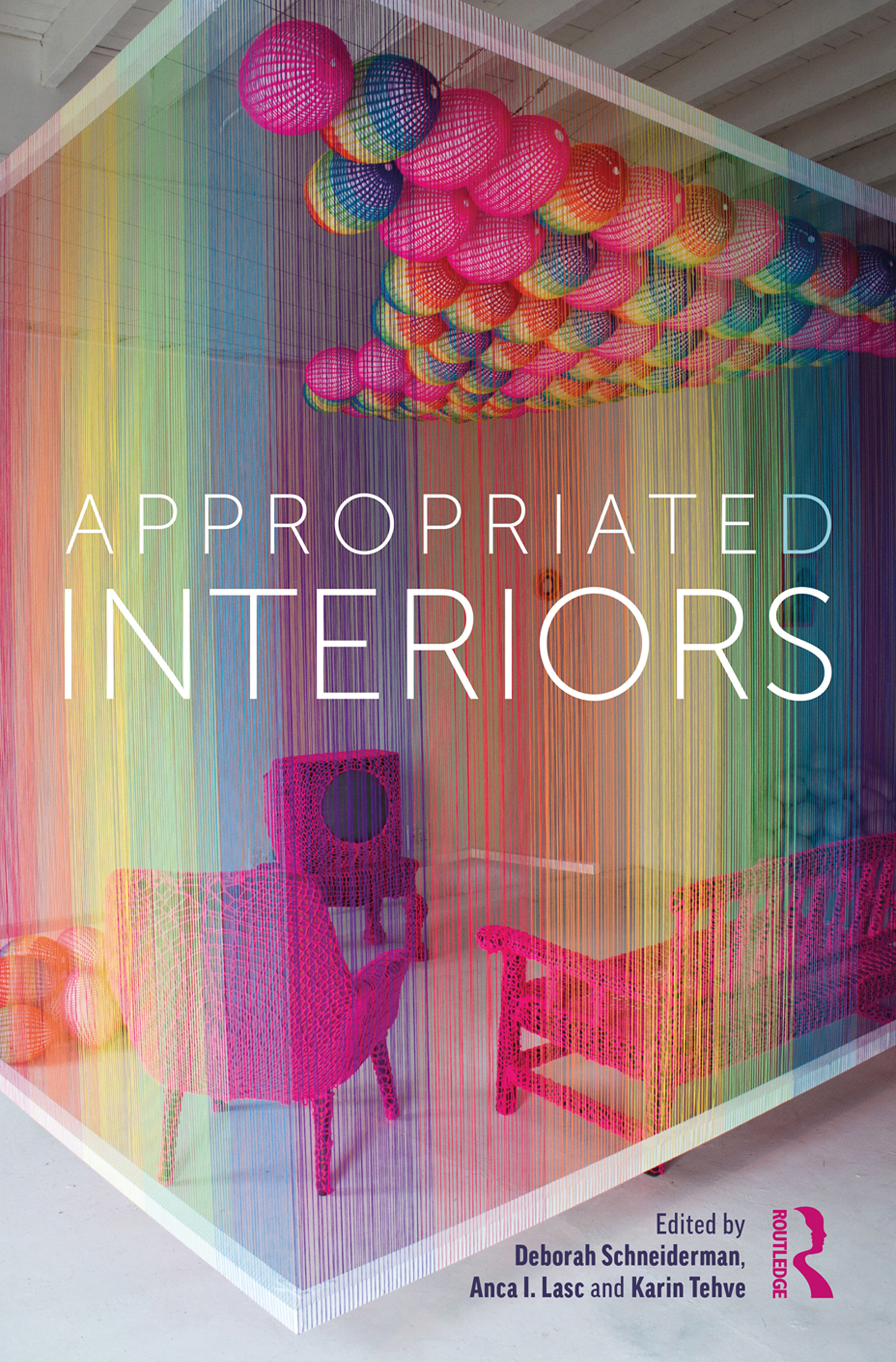 Book cover with text reading Appropriated Interiors over rainbow colored interior space with red chairs and a cluster of spheres on the ceiling