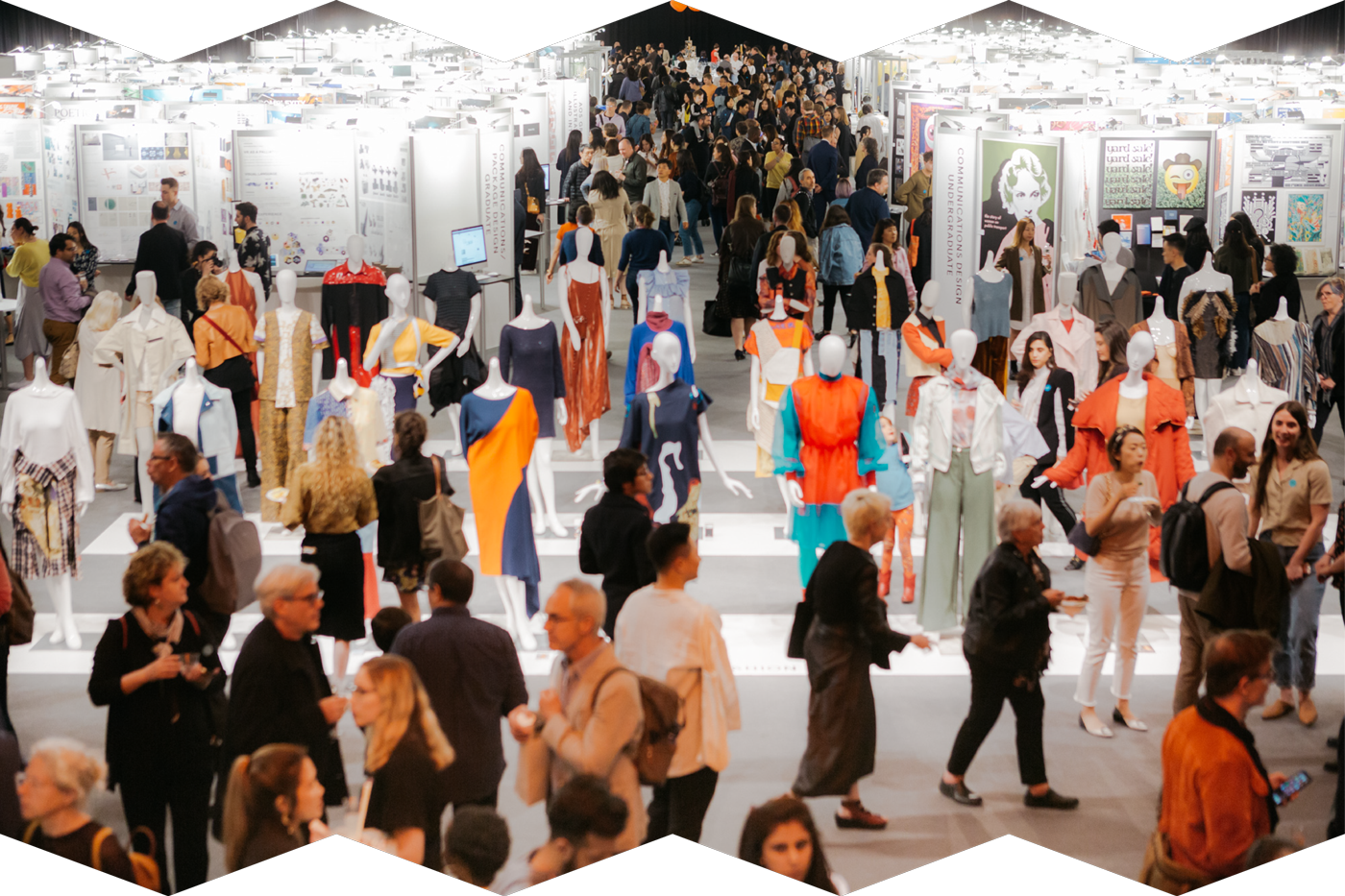 A photograph showing a large group exhibition of design pieces: fashion, communications design, and more. The space is full of people viewing and admiring the work.