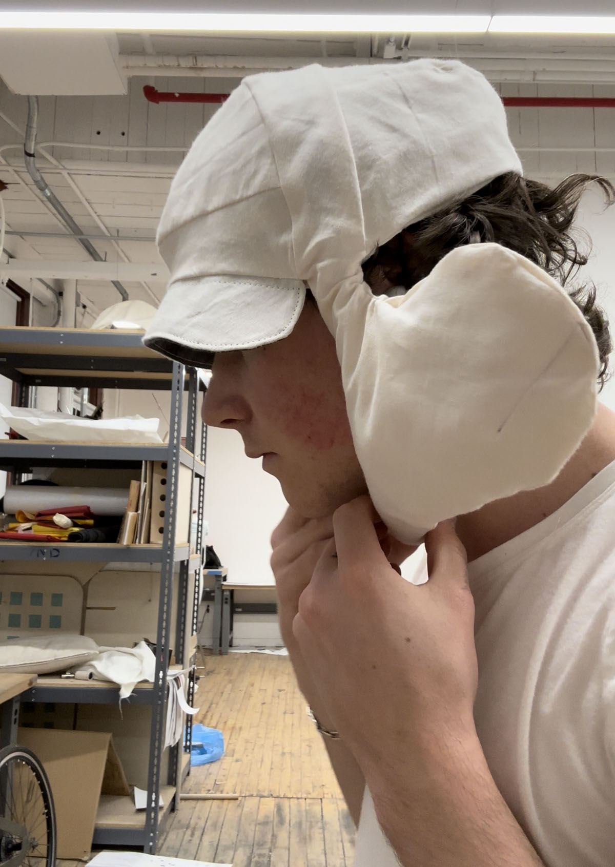 Myles Chisholm displaying one of his prototypes for a calming hat.