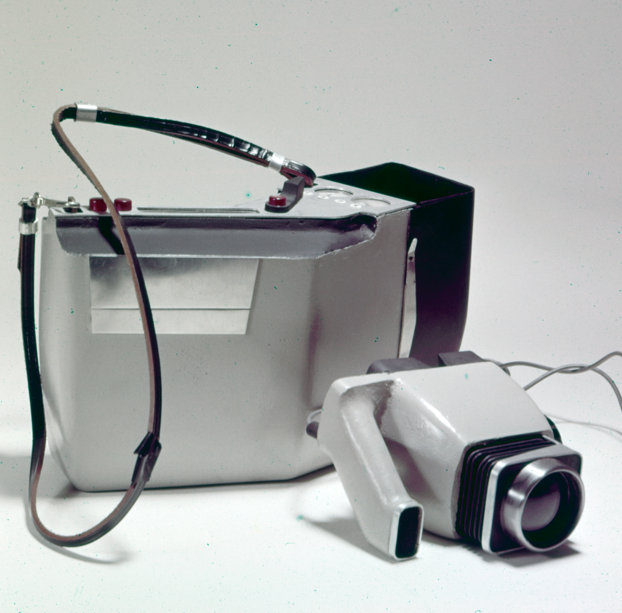 a small gray camera with a larger case