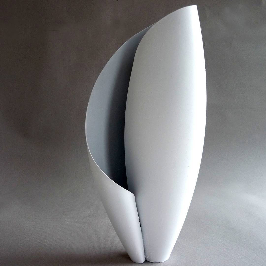 a vase made of a curled white plane