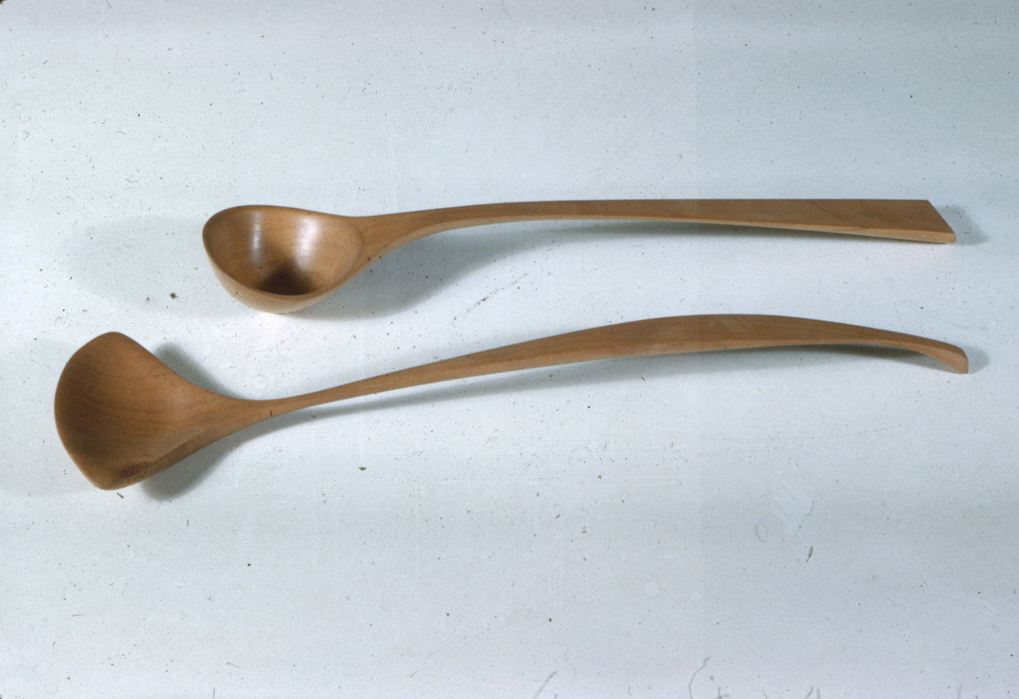 two long wooden serving spons