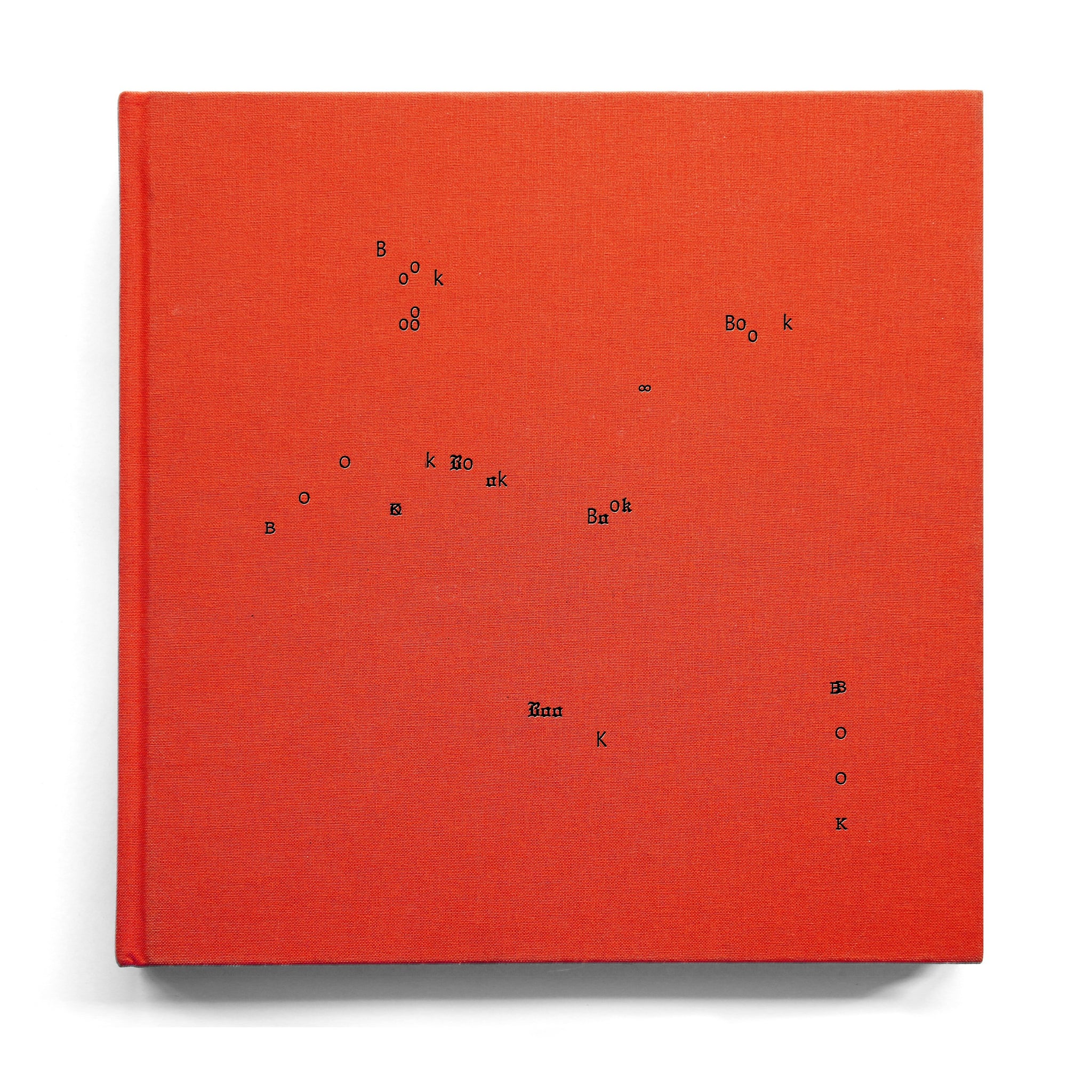 A red cloth-bound book cover with the word “BOOK” repeated seven times, with completely freeform formatting, as well as one infinity sign.