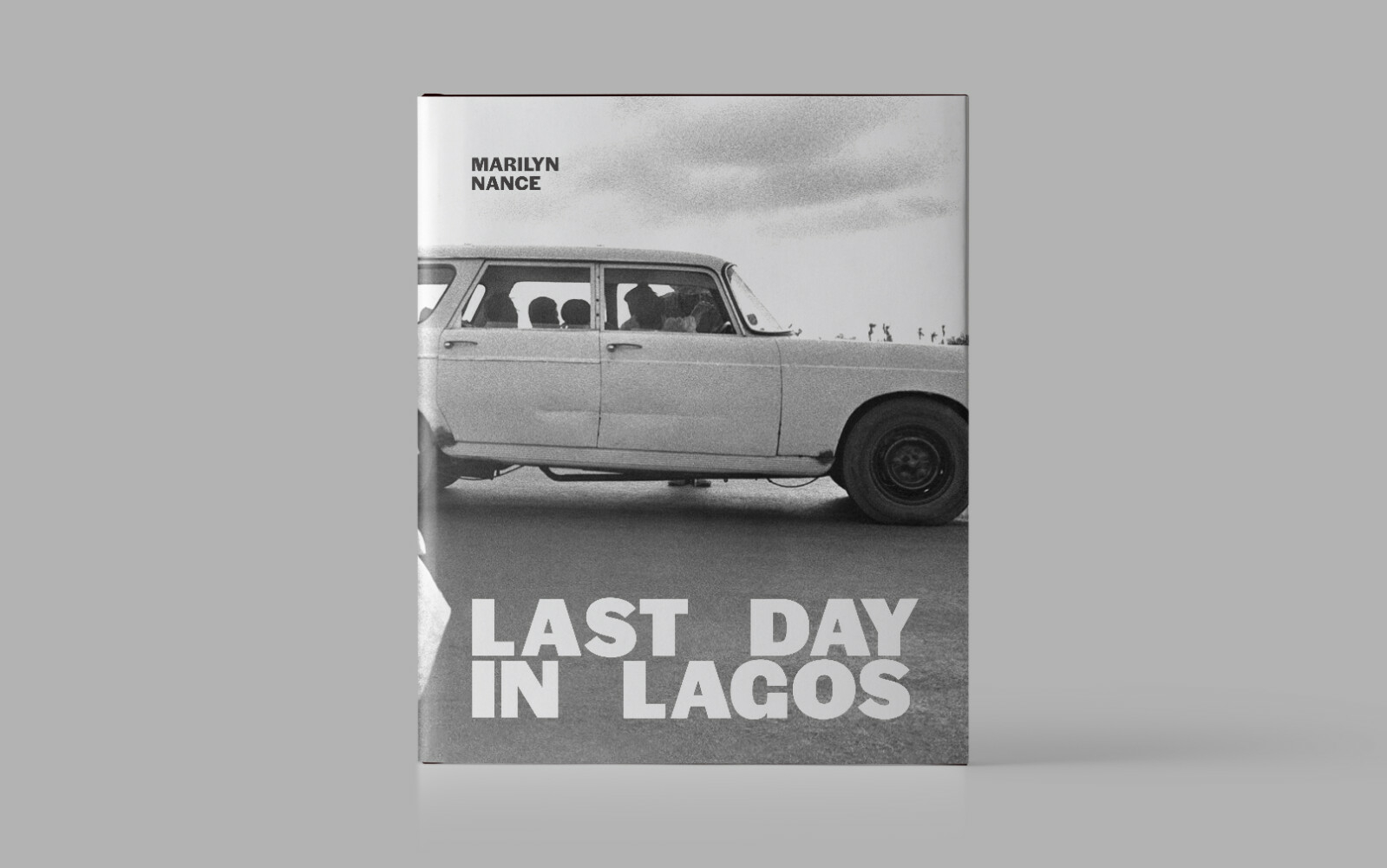 A book cover featuring a black and white photograph of numerous people in a car.