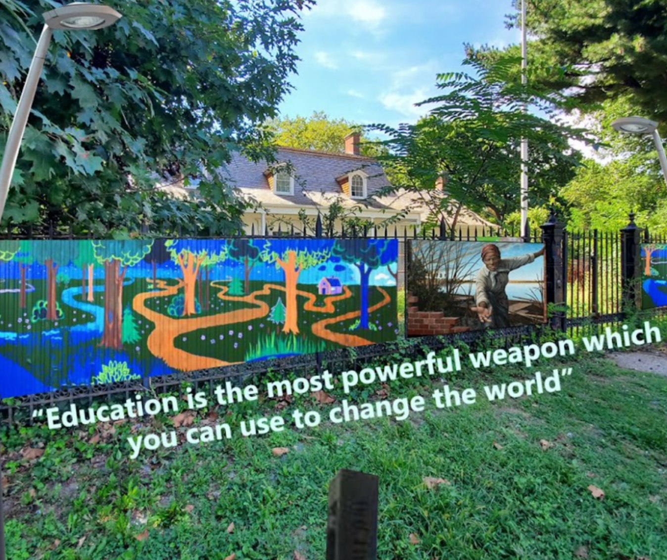 Photo rendering of fence mural with Harriet Tubman and quote: Education is the most powerful weapon which you can use to change the world.
