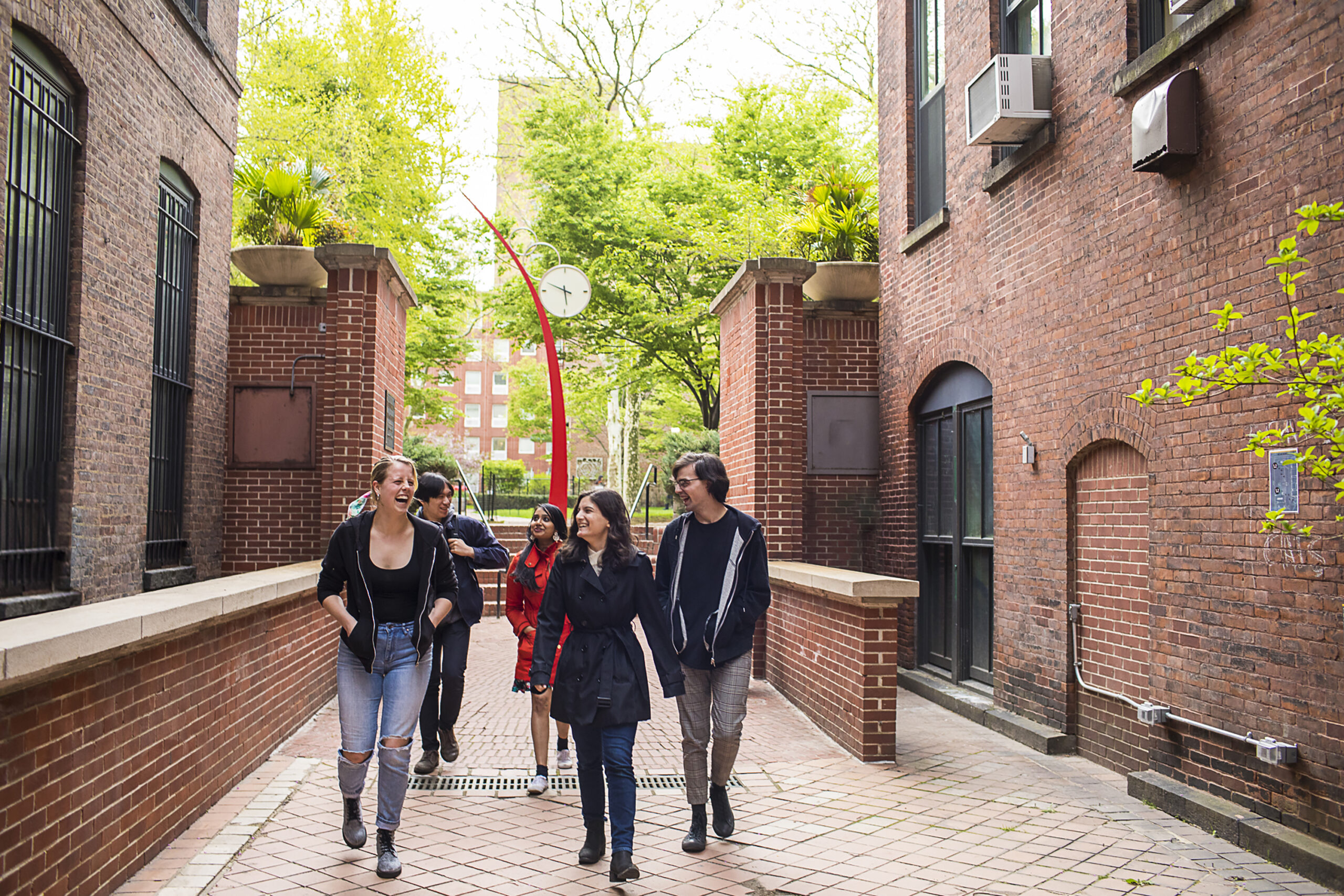 Students chatting casually as they walk through campus.