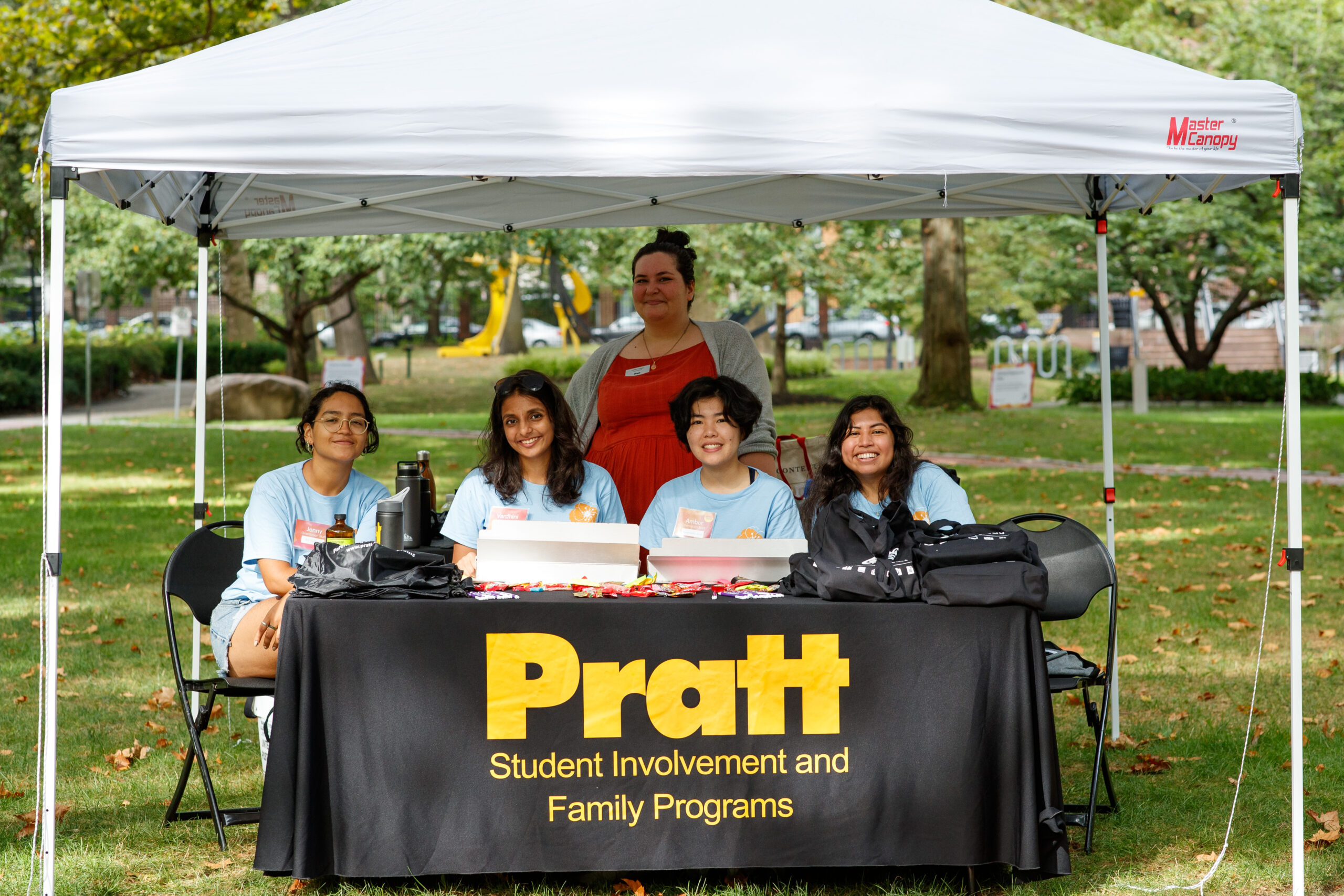 Student volunteers at an information table during student orientation.