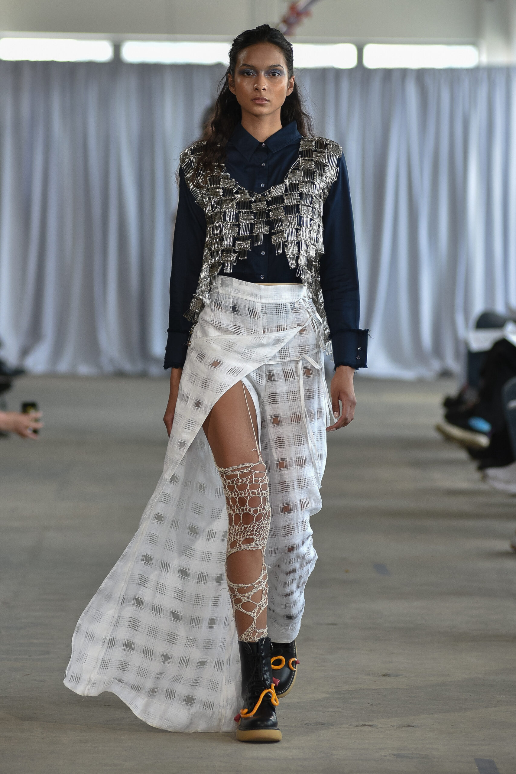 Model in flowing dress with metallic ornamentation by designer Dan Li