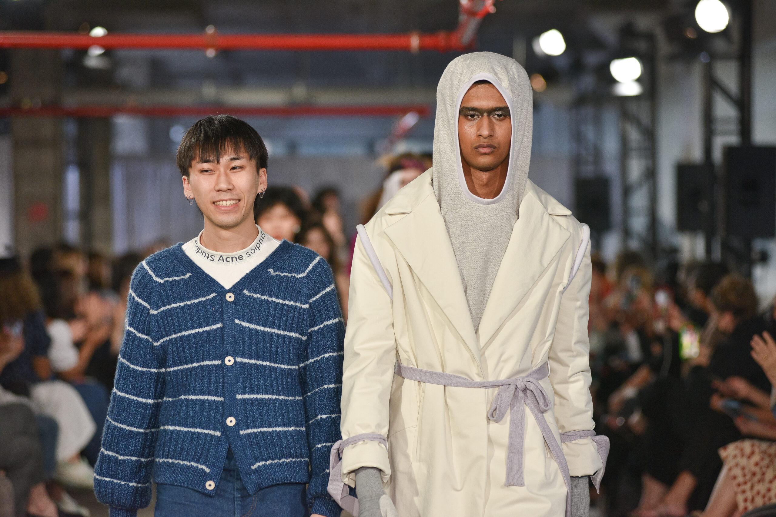 Designer Trung-Tin Pham, BFA Fashion, 2022, with model in hooded wrap coat
