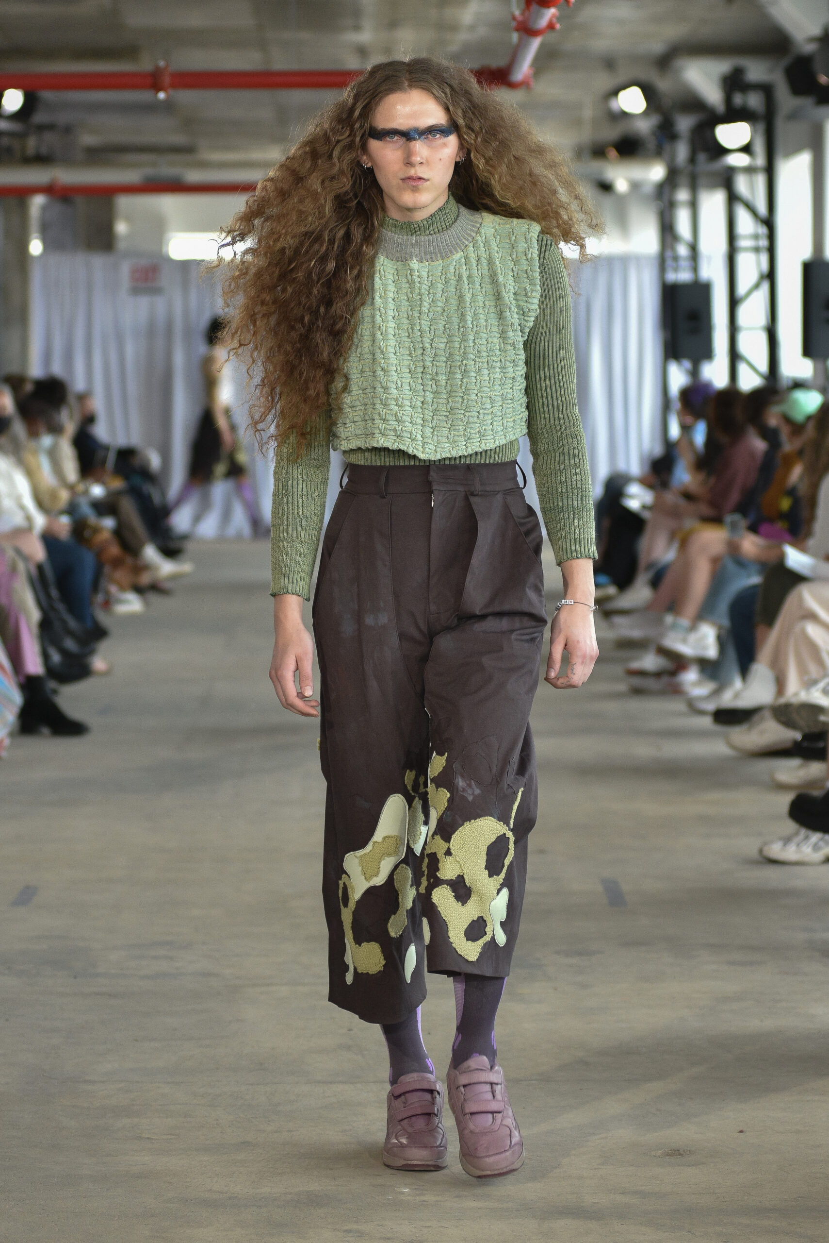 Tall, long haired model in fashion design by Trung-Tin Pham, BFA Fashion, 2022