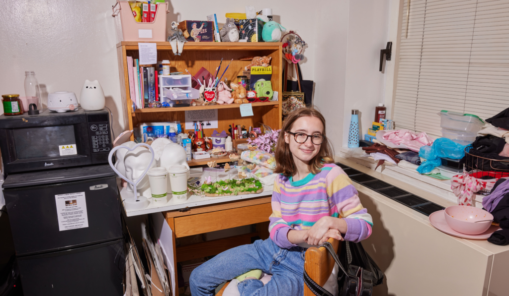 female student, seated in chair, at personal desk, in dorm