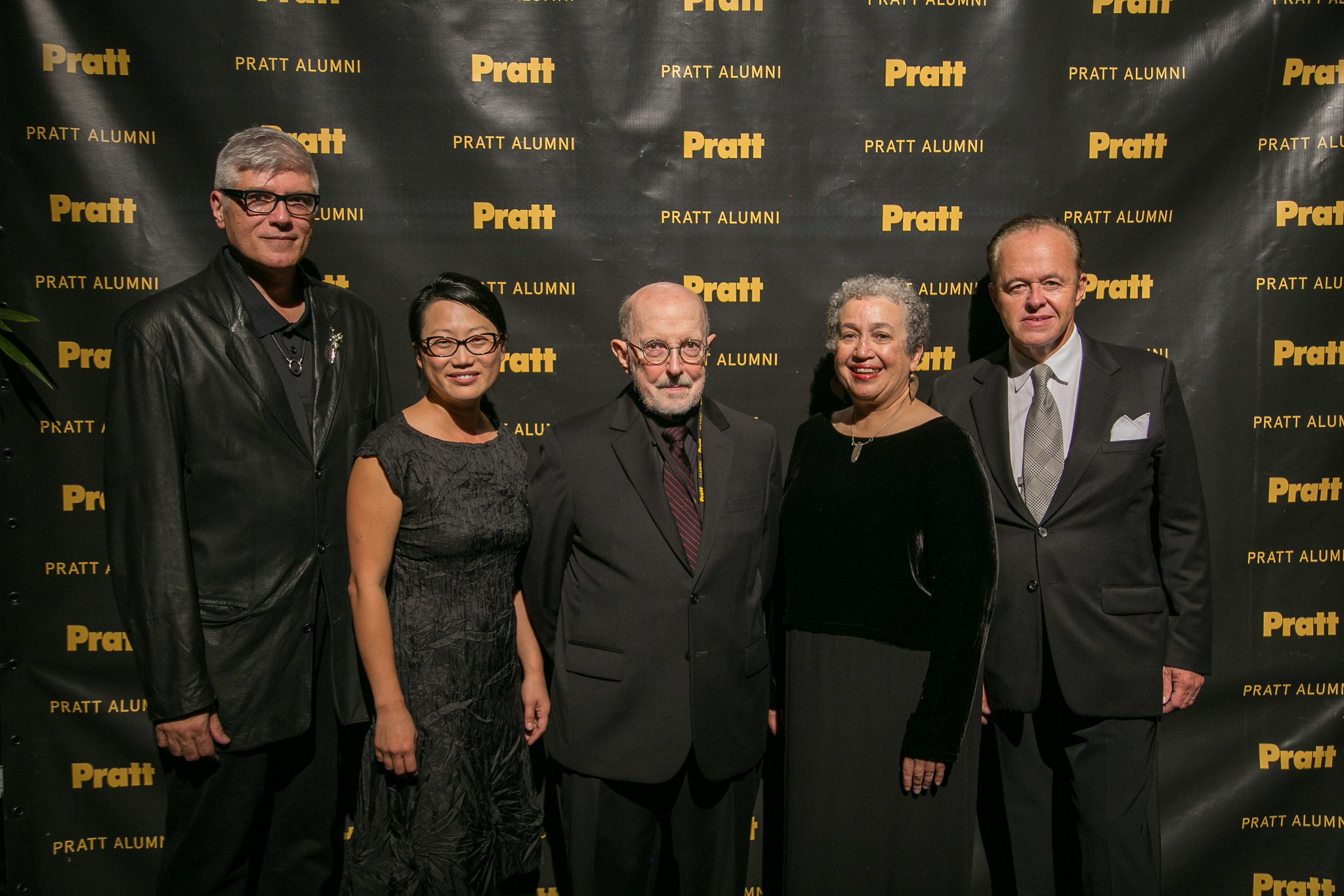 five people, standing and smiling