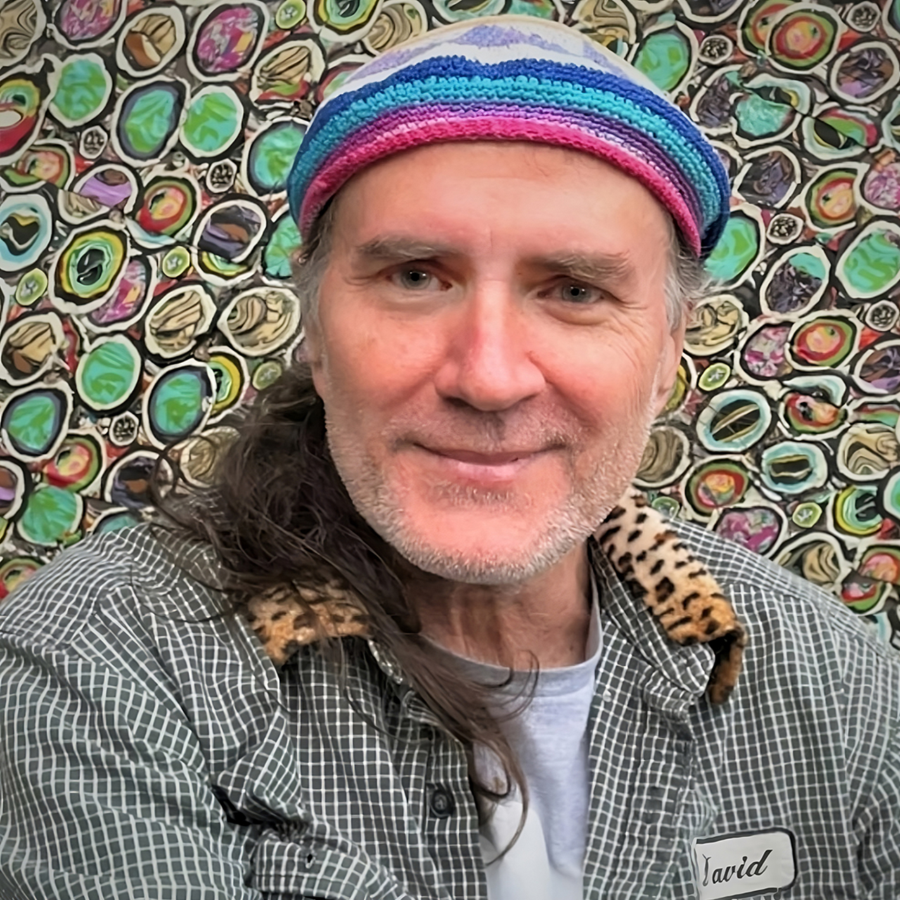 Portrait of David Daniels with an abstract background.