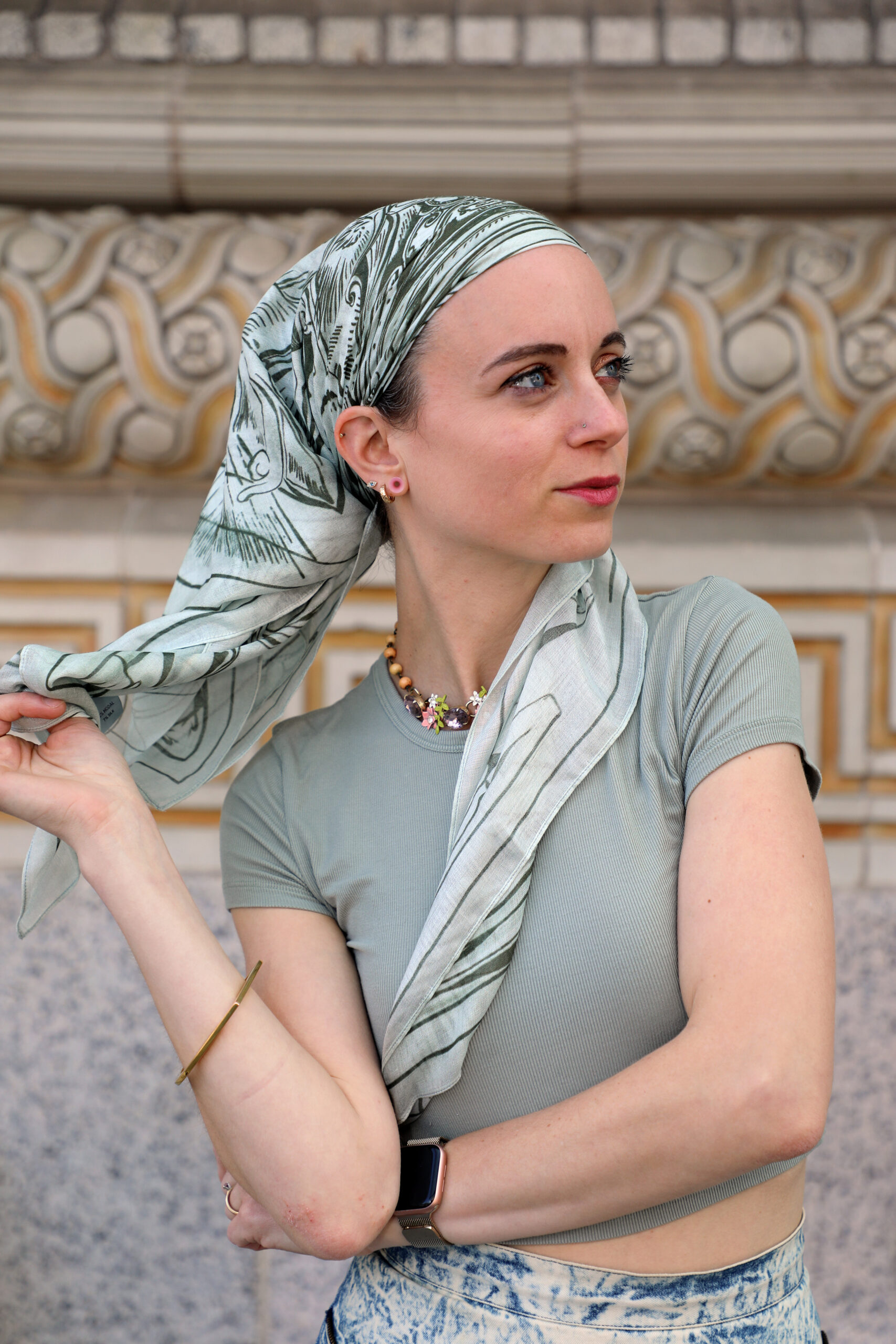 A photograph of a person wearing a white scarf.