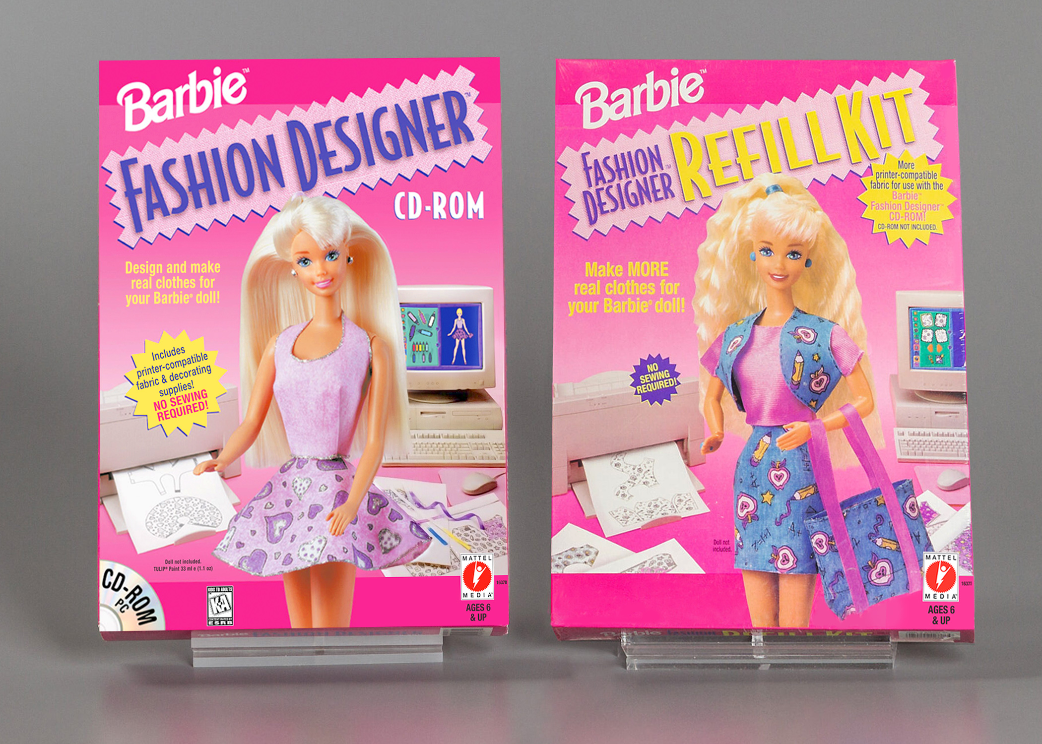 A photograph of two pink Barbie video game packages, featuring blonde female-presenting dolls surrounded by supplies for making clothes.