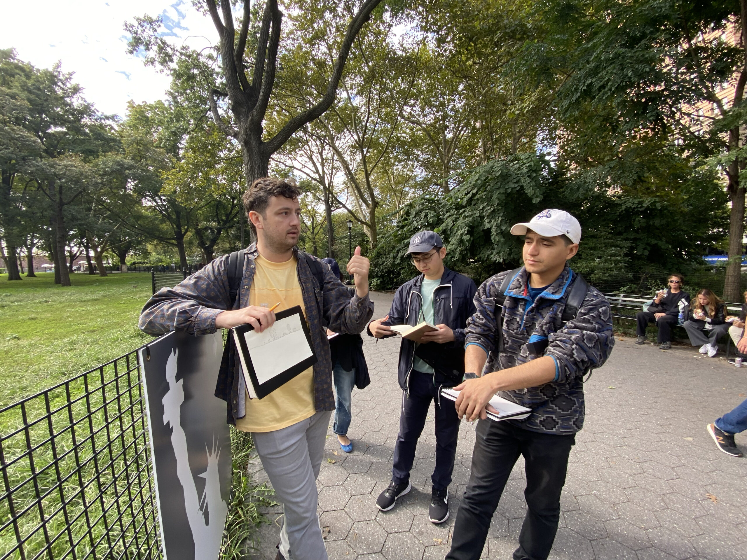 Students in Pratt's MLA program standing in The Battery for a sketching exercise.