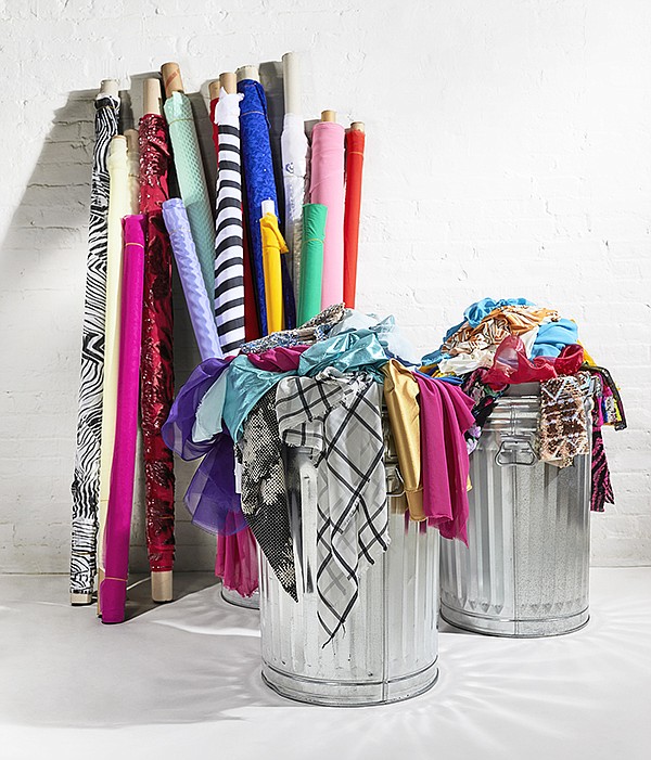 Image of a couple tins with fabric scrap, with markers of variety of colours behind them.