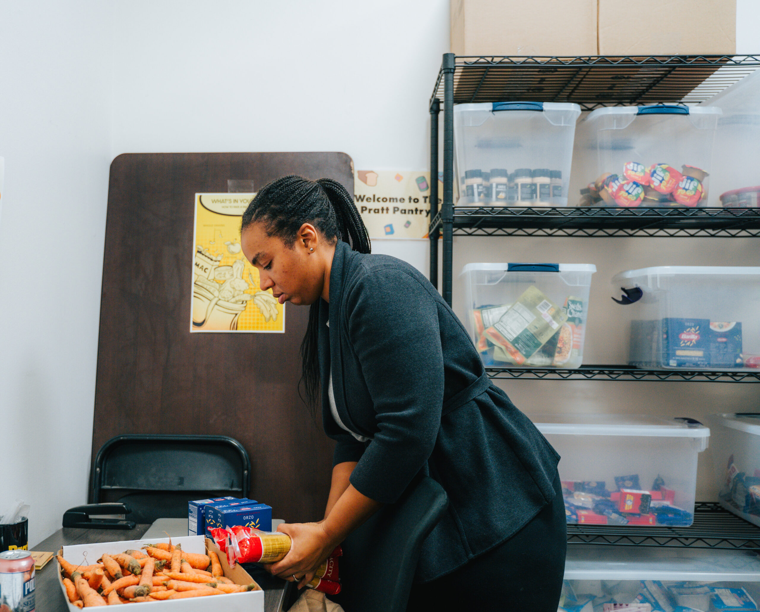 A Pratt Pantry member. stocking the Pratt Food Pantry.