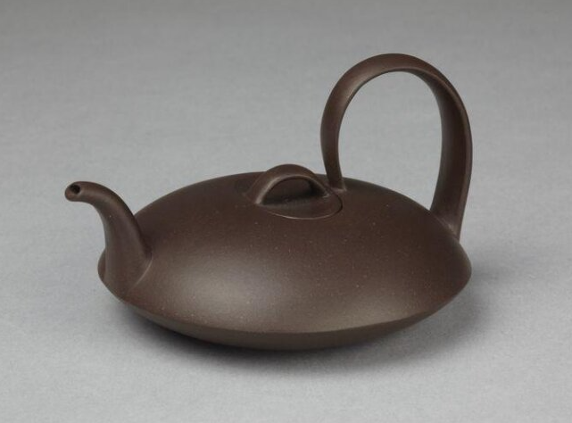 color photograph of a squat brown teapot