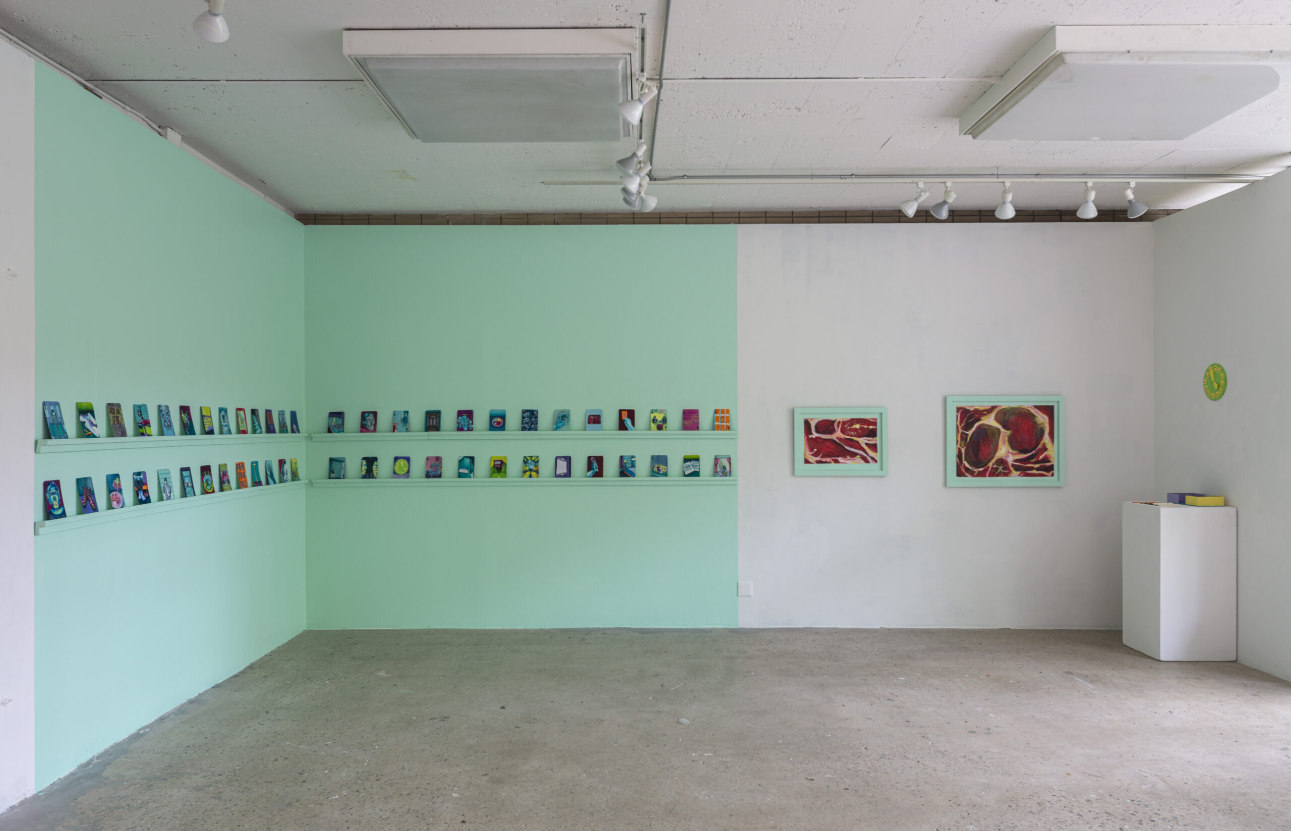 gallery room, with many drawings hanging in a row, across whole room