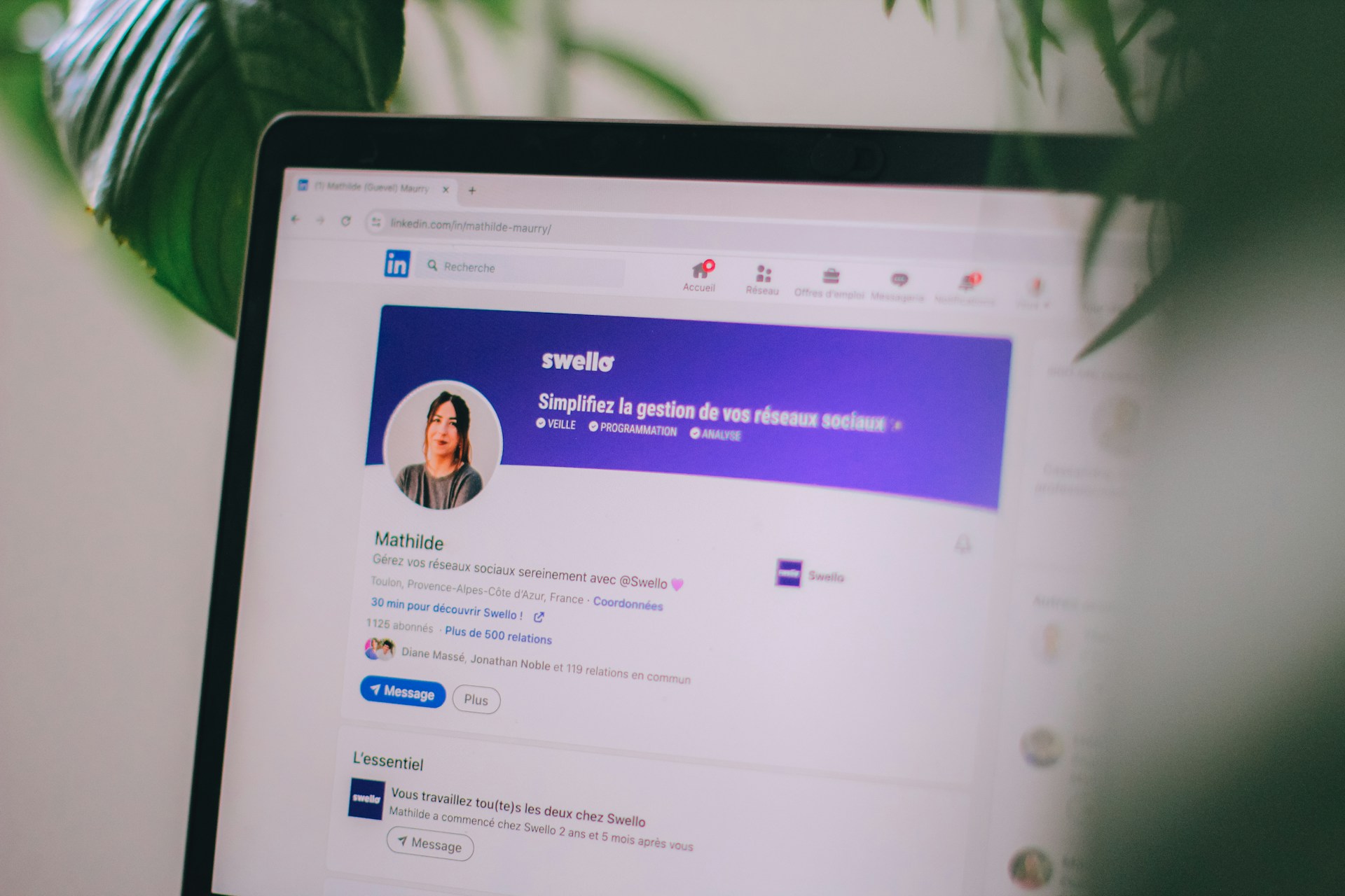 Close-up of a laptop screen displaying a LinkedIn profile page for Mathilde Maury. The profile header includes a blue banner with the Swello logo and the text