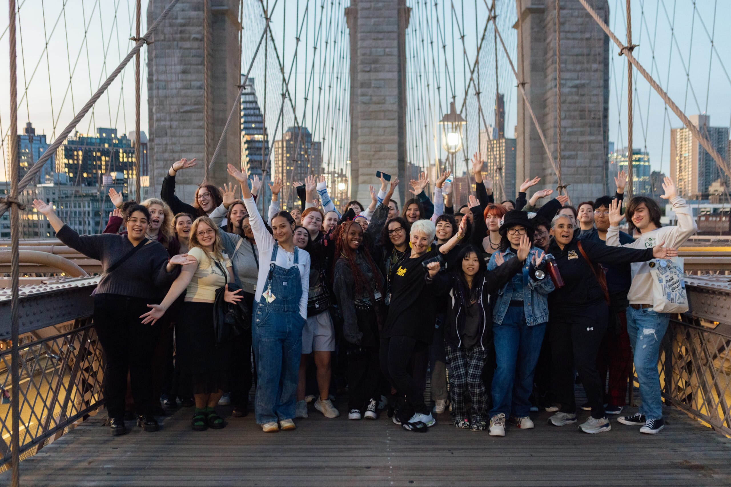 President Frances Bronet (front row, center) with students on the sunrise Brooklyn Bridge walk during orientation week
