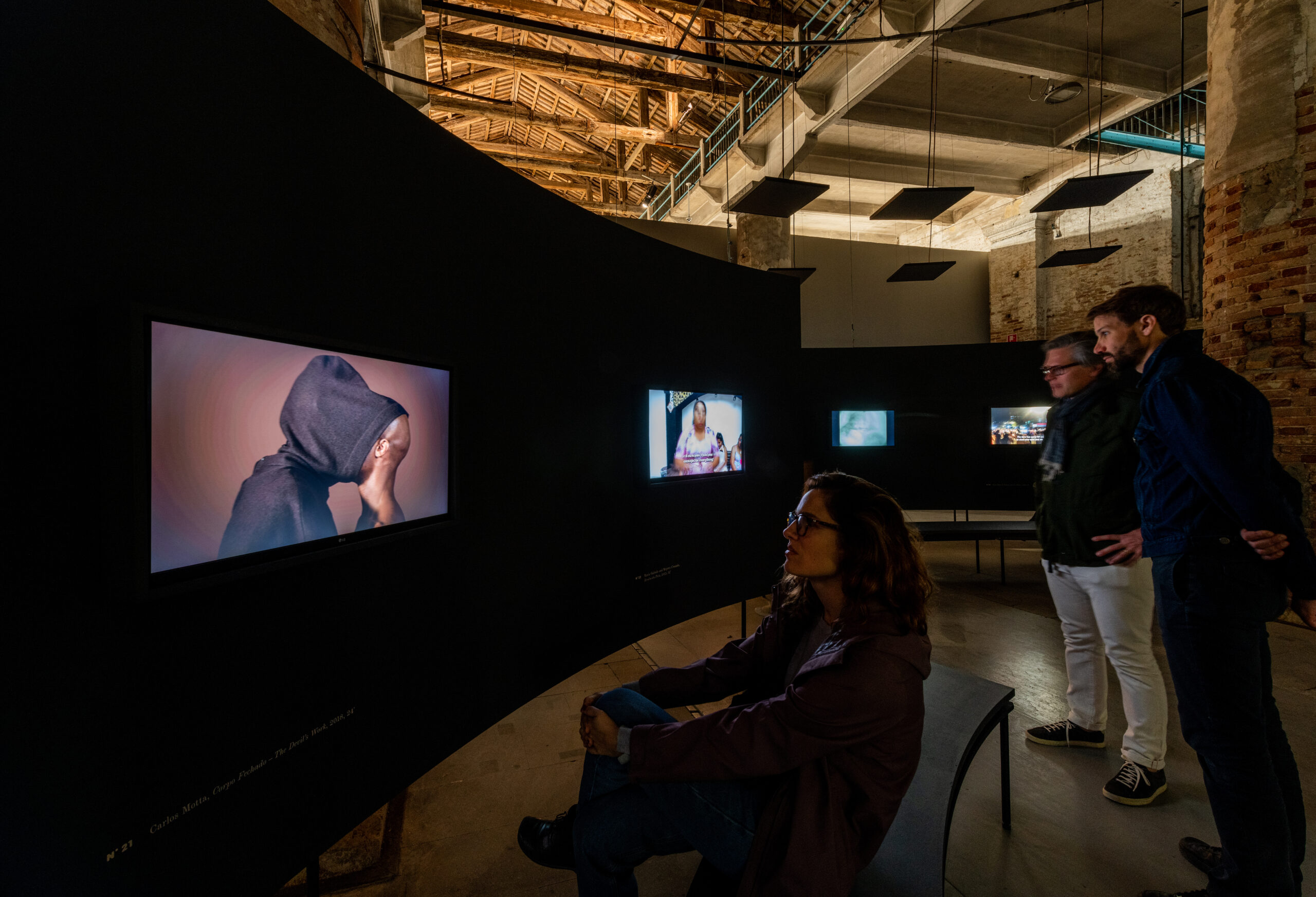 Curved wall featuring three screens.