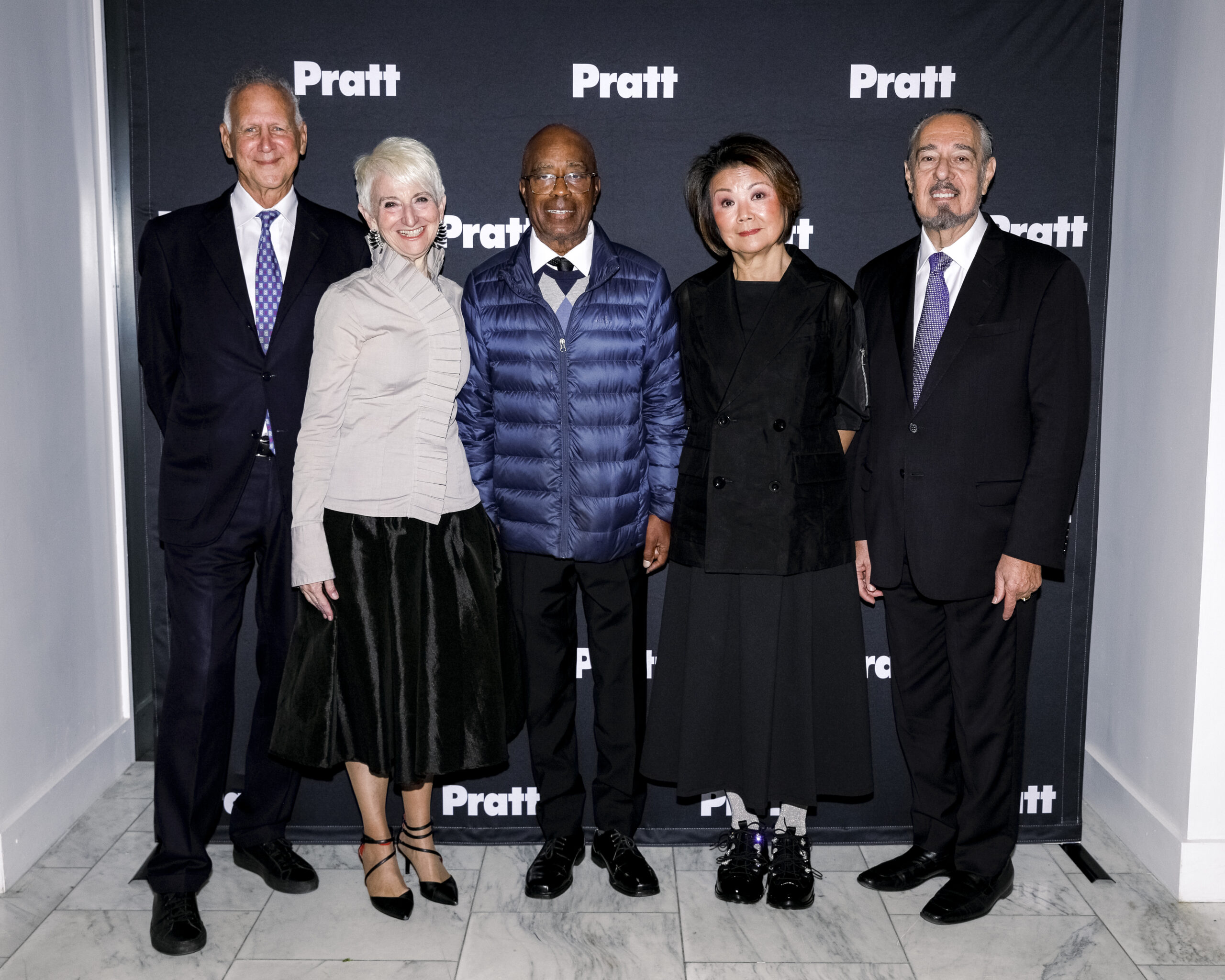 Left to right: Gary Hattem, Frances Bronet, Charles Burnett, Toshiko Mori, Marc A. Rosen standing in front of the Pratt photo background