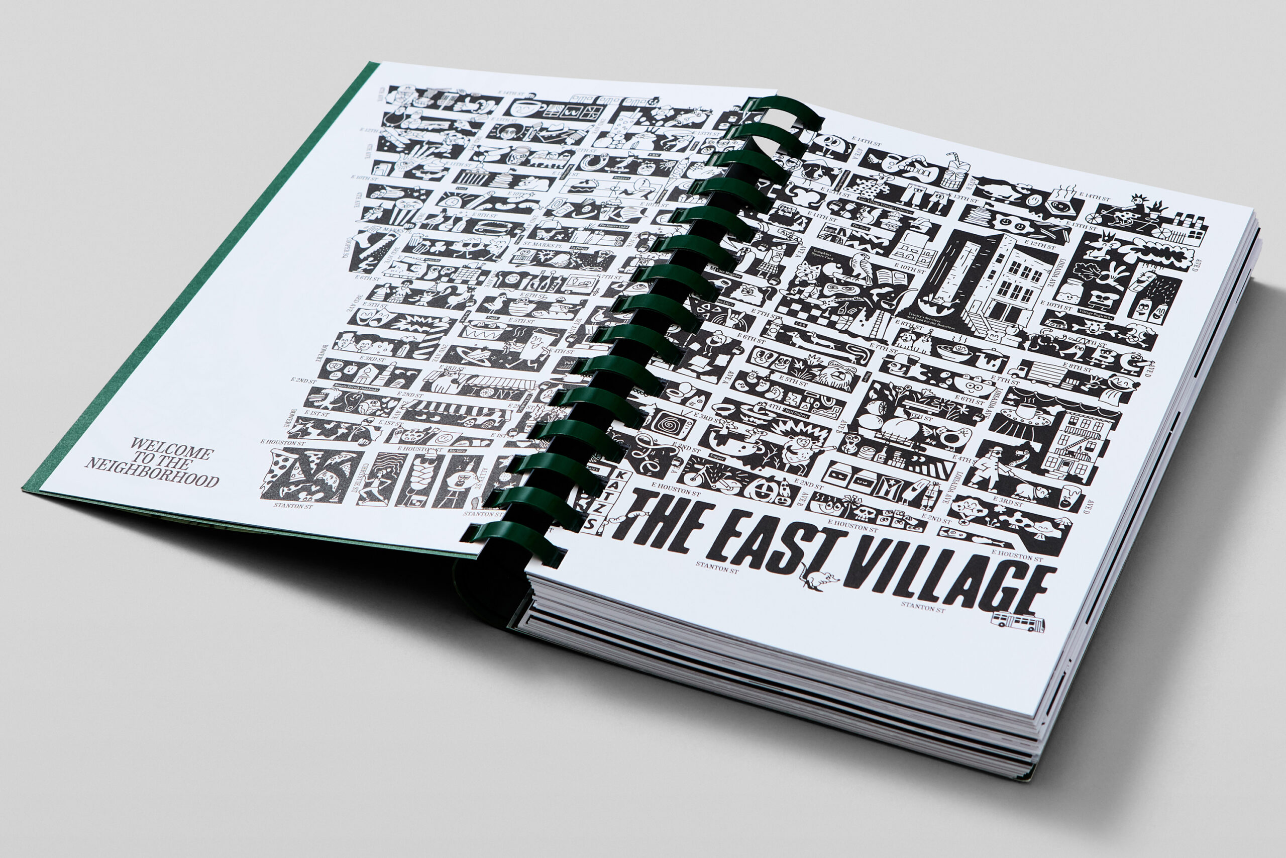 Copy of East Village Cookbook opened against a white backdrop with its transparent overlay turned so that the pastel green cover underneath is visible.