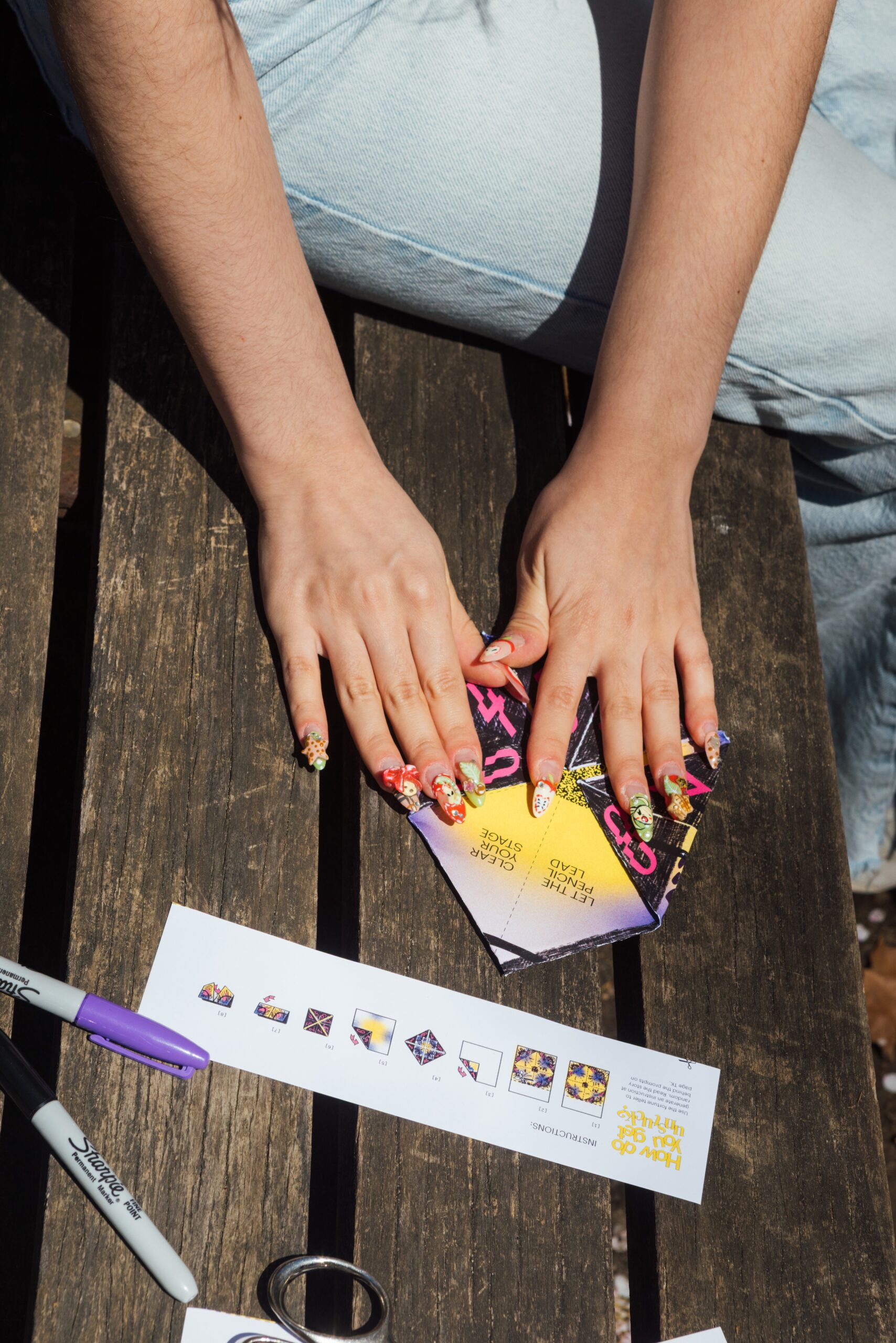 Close-up of someone making a fold on the paper fortune teller
