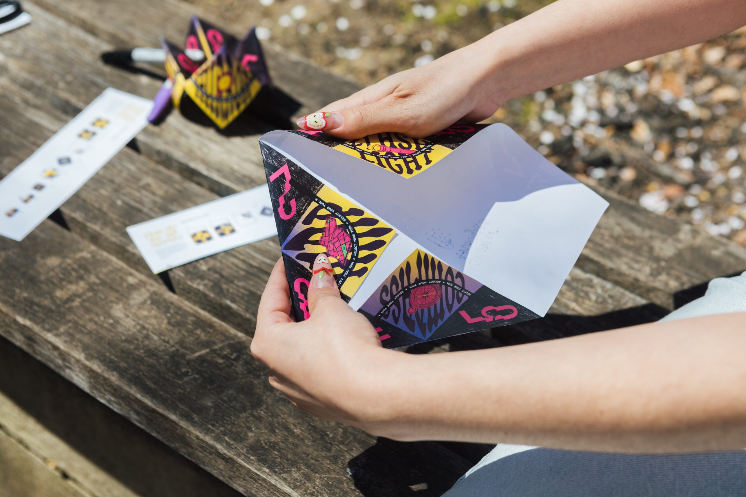 Close-up of someone's hands folding up the paper fortune teller