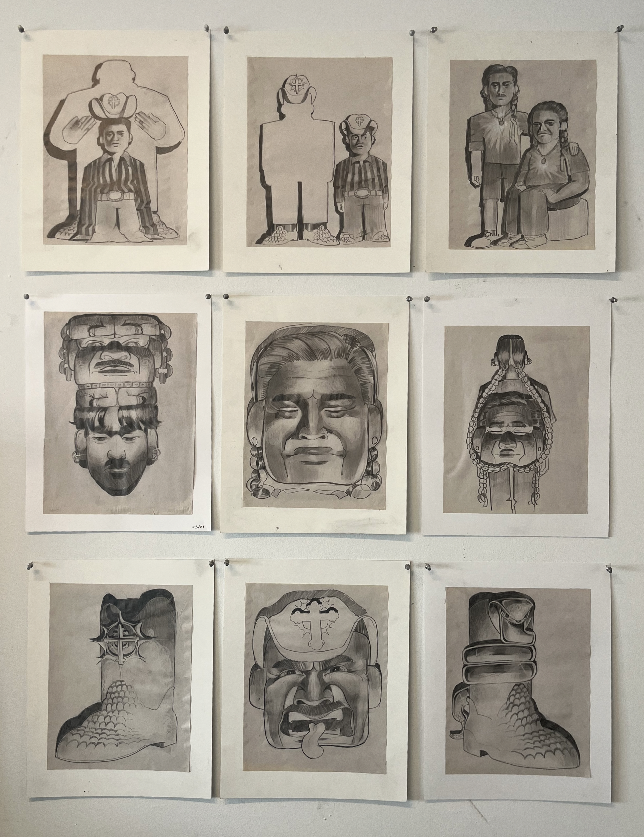 A grid of nine detailed graphite drawings pinned to a wall, featuring stylized faces, boots, and figures in bold compositions.