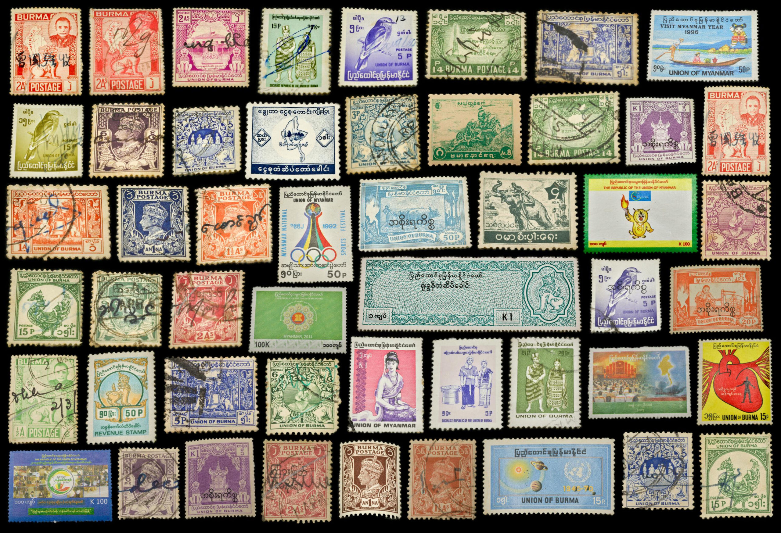 Grid layout of colorful vintage postage stamps from Burma and Myanmar, each with distinct imagery and design. The stamps include portraits, birds, Olympic rings, historical monuments, and traditional scripts in Burmese. Many stamps are marked with postmarks, suggesting use and circulation.