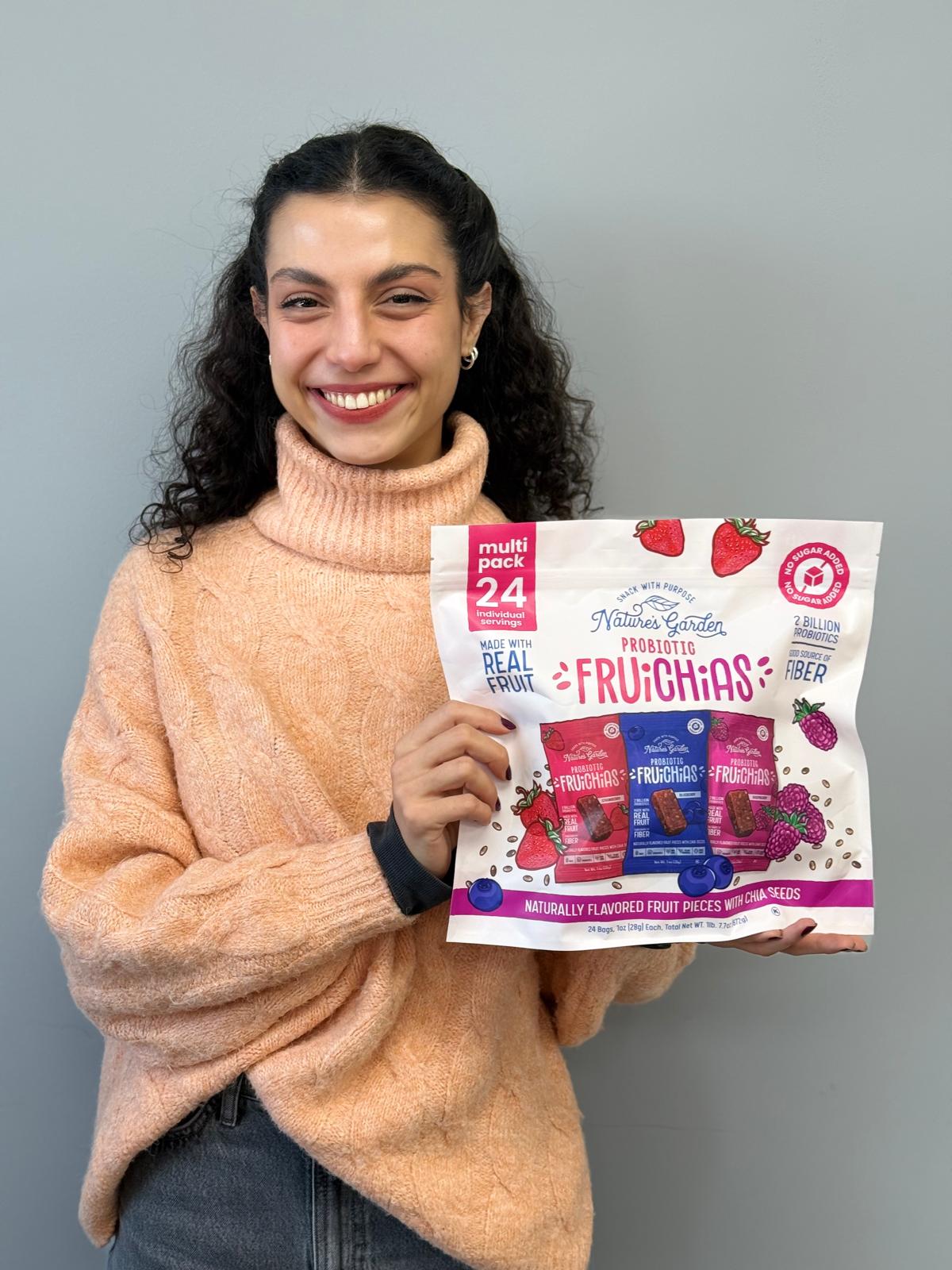 Isik Erturk poses with a Fruichias package featuring brightly colored fruit