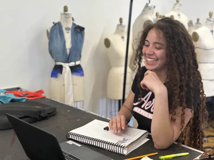 PreCollege student looks off camera while drawing